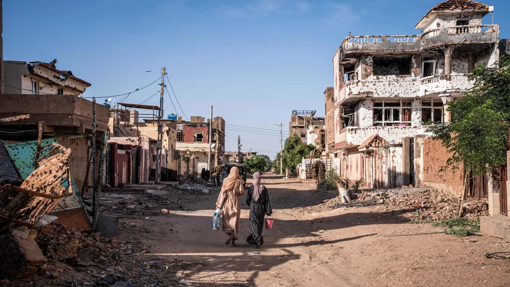 Frauen gehen am 2. November 2024 durch ein vom Krieg zerstörtes Viertel in Omdurman, der zweitgrößten Stadt im Sudan. Der Krieg im Sudan brach im April 2023 zwischen den sudanesischen Streitkräften unter Abdel Fattah al-Burhanund und den paramilitärischen Rapid Support Forces (RSF) unter seinem ehemaligen Stellvertreter Mohamed Hamdan Daglo aus. © Amaury Falt-Brown / AFP / picturedesk.com
