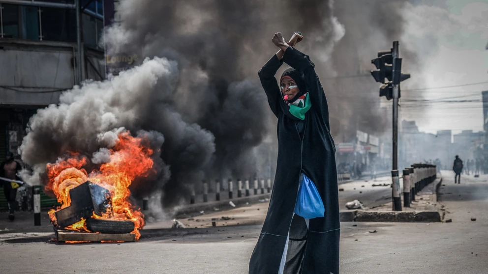 Eine Demonstrantin vor einer brennenden Barrikade, Nairobi, Kenia, 25. Juni 2025. Bei Protesten ein Jahr zuvor waren mindestens 60 Menschen von den Behörden getötet worden, Aufarbeitung fehlt. © Luis Tato / AFP via Getty Images